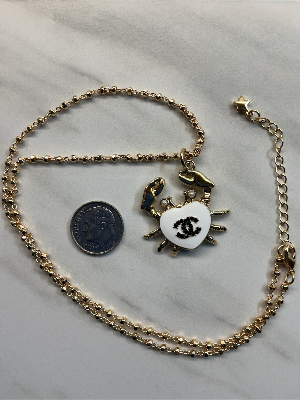 Gold-Tone Crab Pendant Necklace with White Enamel Heart and Black Logo - Picture 3 of 7
